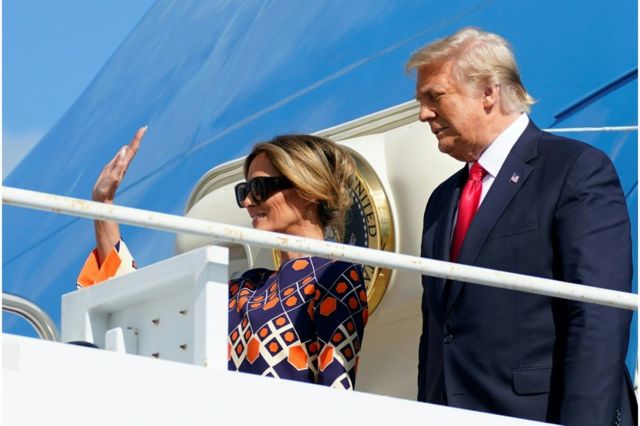 President Donald Trump and First Lady Melania Trump wave from Air Force One