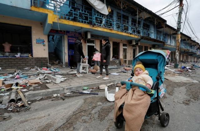 People gather outside a shopping centre destroyed during Ukraine-Russia conflict in the southern port city of Mariupol, Ukraine April 14, 2022.