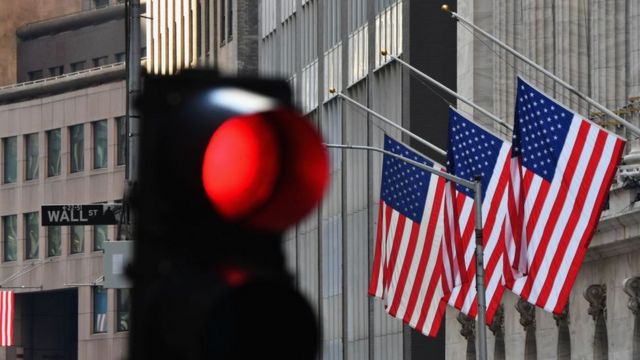 Traffic light and flags on Wall Street