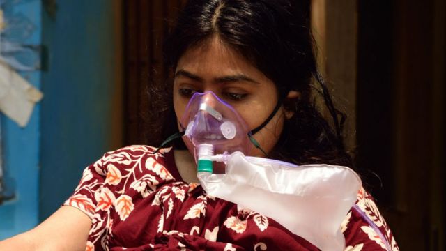 2021年4月24日，印度加尔各答的新冠疫情急剧恶化，图为一名患者在医院外戴着医用氧气面罩。