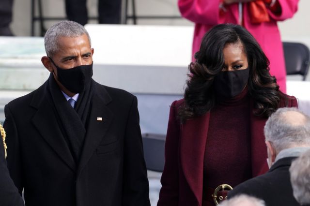 Former President Barack Obama and former first lady Michelle Obama arrive at the inauguration whilst wearing masks