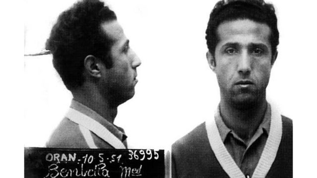 تم اعتقاله عام 1950 بعد غارة على مركز البريد الرئيسي في وهران لتمويل أنشطته الثورية