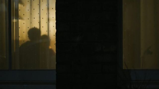 A still from the abused by my girlfriend documentary showing shadows of a couple through window