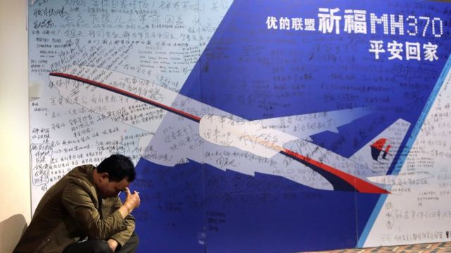 北京丽都酒店内一名MH370乘客家属坐在地上抽烟（29/3/2014）