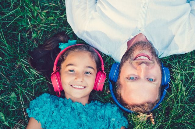 father and daughter listening together