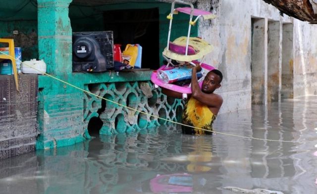 A resident evacuates furniture after rain water flooded his home in Mogadishu, Somalia May 21, 2018