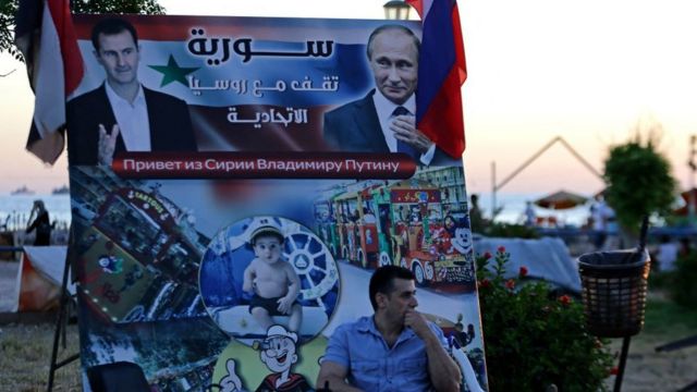 Плакати з Асадом та Путіним