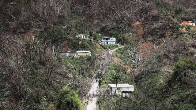 Community members gather in the street nearly three weeks after Hurricane Maria hit the island, on October 10, 2017 in Pellejas, Adjuntas municipality, Puerto Rico.
