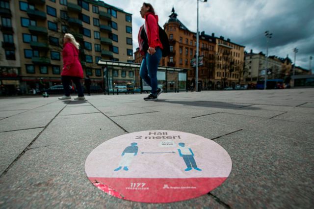 A big sticker of the healthcare services of Sweden on a pavement in Stockholm