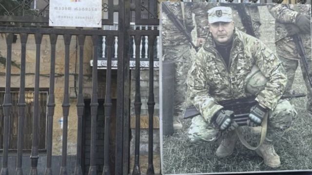 A photo of David Ratiani taped to the door of his house.