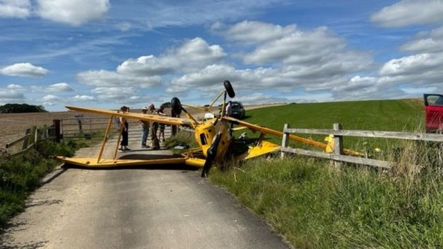 Plane upside down after crashing into power lines