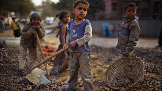 Indian children work nearby to their parents at a construction project in front of the Jawaharlal Nehru Stadium on January 30, 2010 in New Delhi, India.