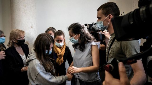 The defendant Valérie Bacot (center) arrives accompanied by her family and surrounded by journalists at the Chalon-sur-Saone Palace of Justice, in west-central France.