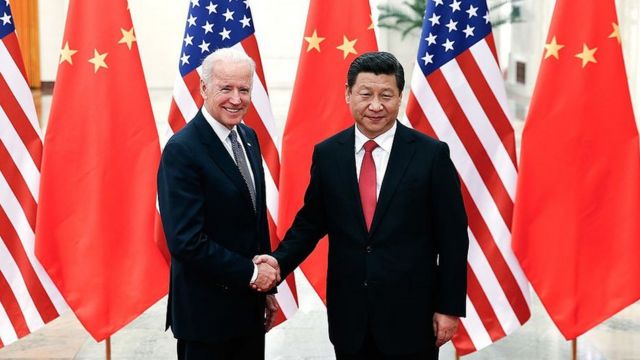 Joe Biden shakes hands with Chinese President Xi Jingping.