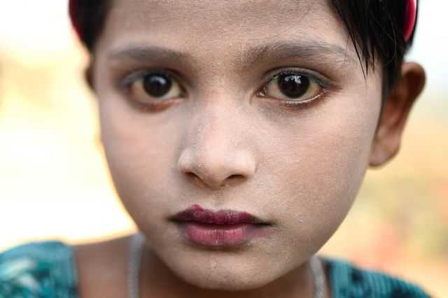 Rohingya refugee Sufaida, aged 7, poses for a photograph as she wears thanaka paste at Kutupalong camp in Cox's Bazaar, Bangladesh