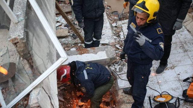 Rescue teams work at the site of collapsed buildings following a powerful earthquake in Hatay, southeastern Turkey, 10 February 2023