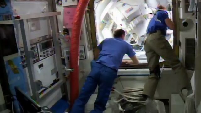 astronauts at the airlock