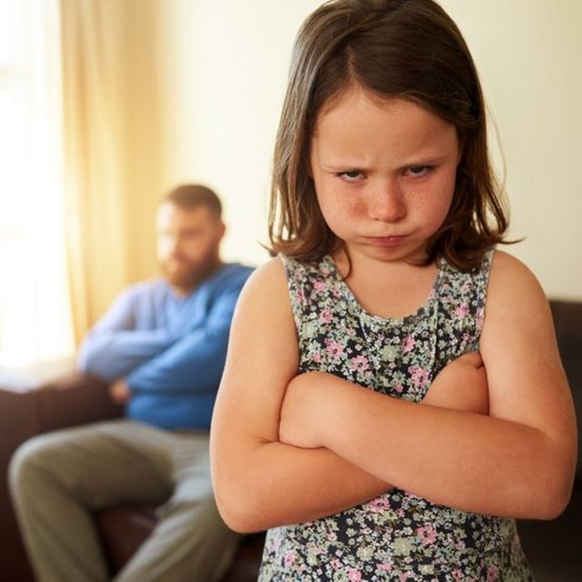 Shot of an unhappy little girl sulking after a disagreement with her father