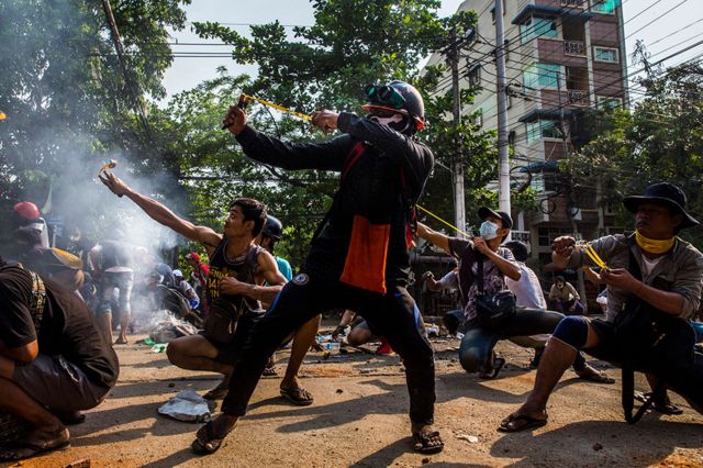 Los manifestantes usan hondas y otras armas caseras en un enfrentamiento con las fuerzas de seguridad en Rangún, Myanmar.
