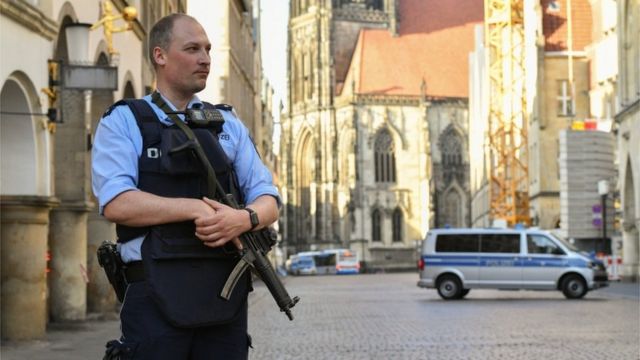 A policeman stands guard in Muenster after Saturday's van attack