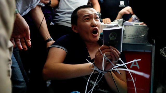 Fu Guohao, reporter of Chinese media Global Times website, is tied by protesters during a mass demonstration at the Hong Kong international airport, in Hong Kong, China, August 13, 2019.