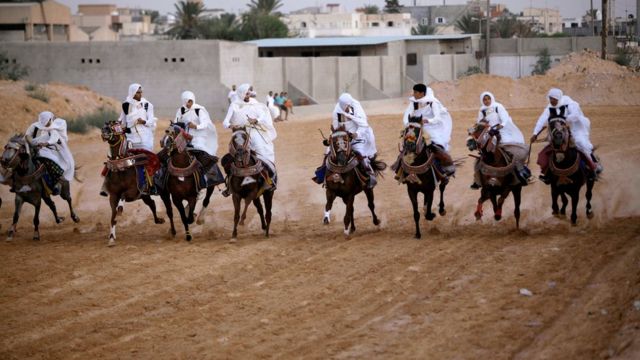 Libyans dressed up in traditional costumes ride horses during a race in Tripoli, Libya, August 19, 2017. Picture taken August 19, 2017.