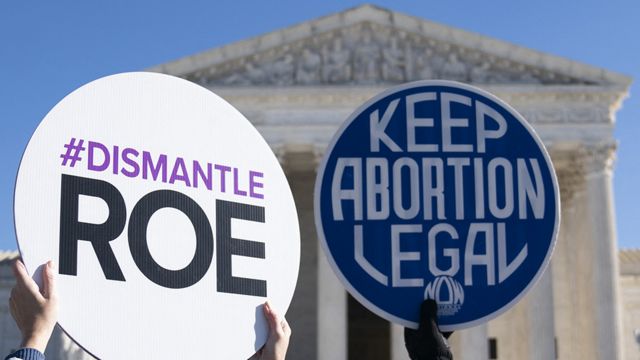 A poster against abortion and another in its defense in front of the Supreme Court in Washington, DC.