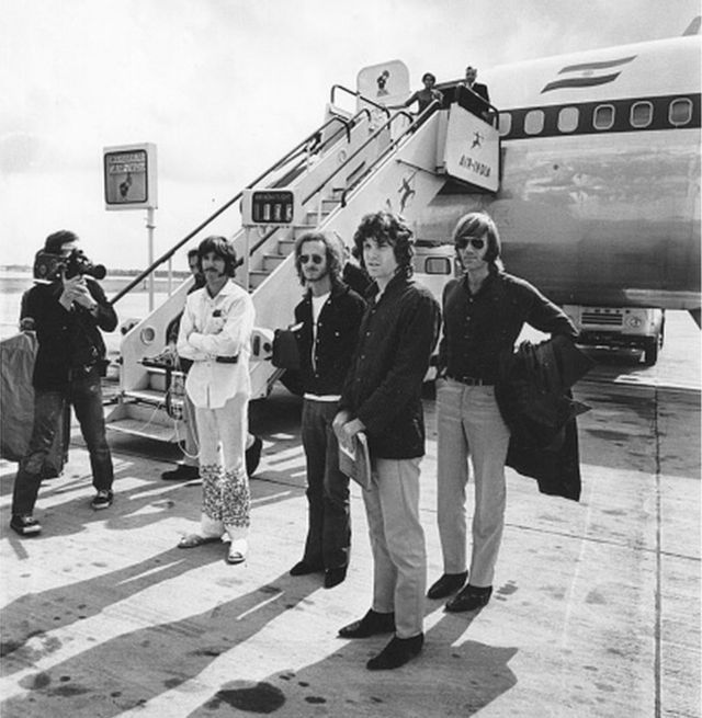 Popular American rock group The Doors standing beside an Air India aeroplane.