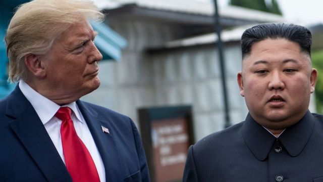 Donald Trump and North Korea's leader Kim Jong-un talk before a meeting in the Demilitarized Zone (DMZ) on June 30, 2019, in Panmunjom, Korea