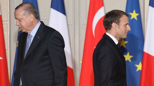 Macron and Erdogan walk during a joint press conference at the Elysee Palace in Paris in 2018