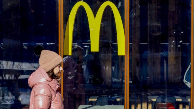 A woman walks in front of a closed McDonald's restaurant in Moscow.  March 2022