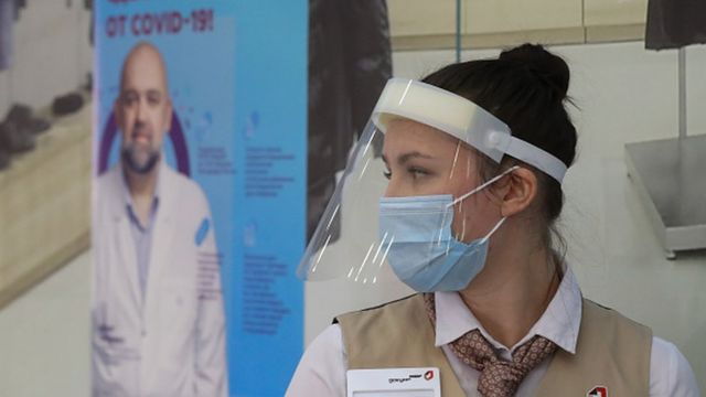 A staff member at the entrance to a temporary Covid-19 vaccination site in the Gagarinsky shopping and leisure centre