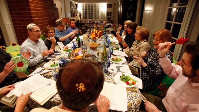 A Jewish family celebrating Passover with the ritual Seder meal