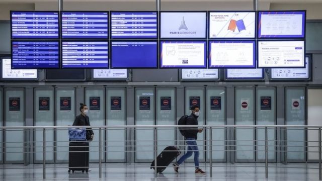 Passengers arrive at Charles de Gaulle Airport, in Roissy, outside Paris earlier this week