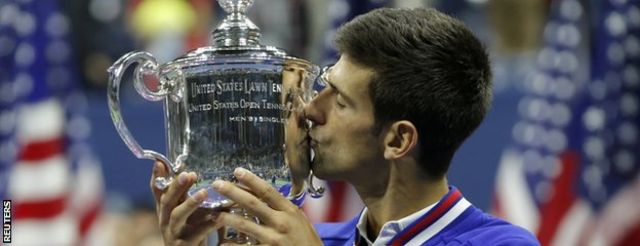 Novak Djokovic kisses the US Open trophy