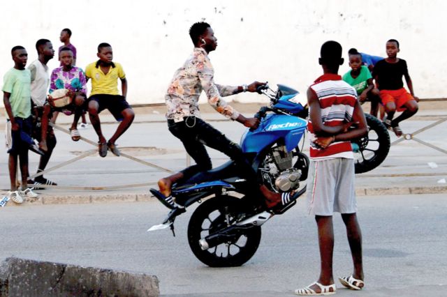 A young man performs on a motorcycle on a street in Abidjan, Ivory Coast on - Wednesday 28 July 2021