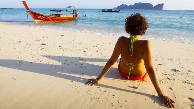 A woman relaxes on a beach in Thailand. File photo