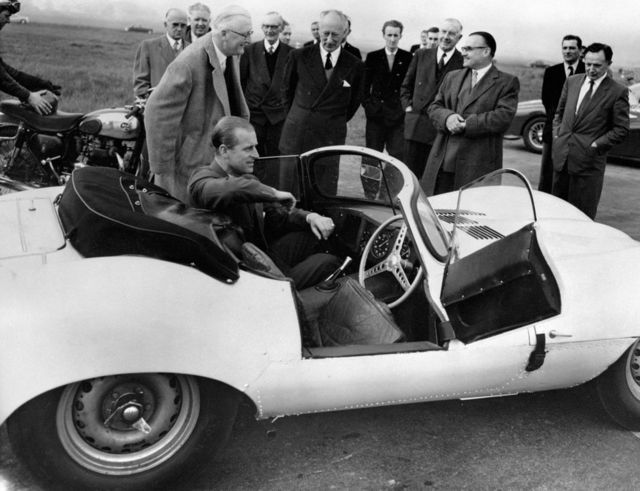 The Duke of Edinburgh is seen trying the passenger's seat of the new 3.5 litre Jaguar XKSS sports car during his visit to the Motor Industry Research Association's headquarters near Nuneaton, Warwickshire