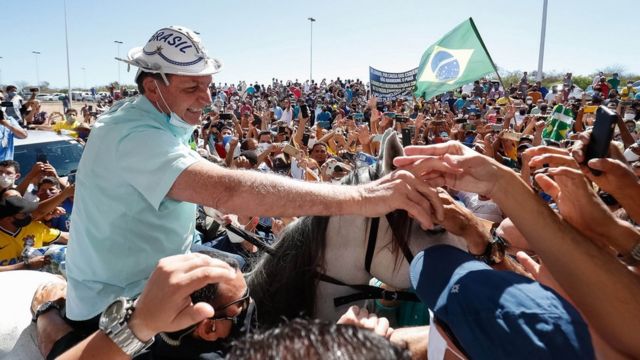 A handout photo made available by the Brazilian presidency in which Brazilian President Jair Bolsonaro is received by hundreds of people on a visit to the city of Sao Raimundo Nonato