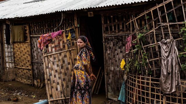 A Rohingya woman stands outside of her tent inside the IDP camps in Sittwe, Rakhine State Myanmar
