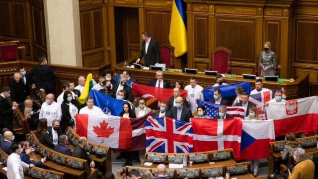 Members of various parties hold foreign countries' national flags during the 7th session of the Verkhovna Rada of the 9th convocation