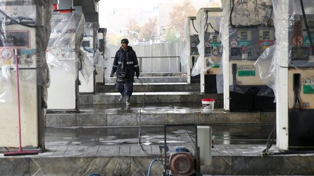 A man walks near the remains of petrol pump stands, during protests against increased fuel prices, in Tehran, Iran, 20 November, 2019.