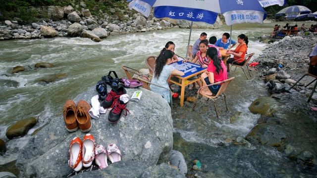 Mahjong players in a river