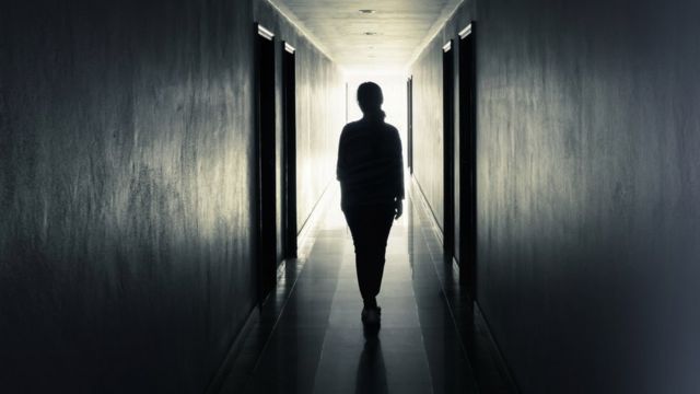 Silhueta de mulher em corredor