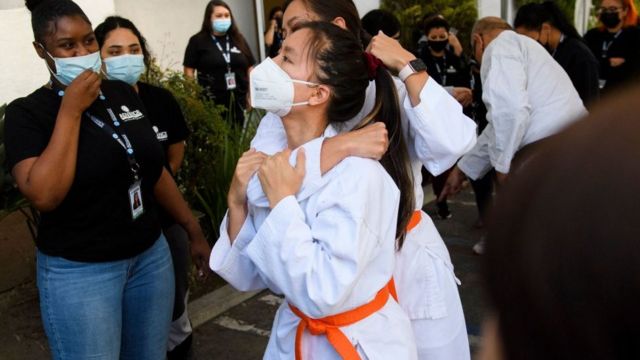 Megan Nguyen (C) and Emily Nguyen of the Vietnam Martial Arts Center demonstrate techniques during a self-defense training class