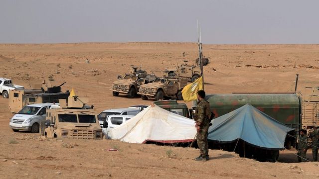 Coalition forces and members of the Syrian Democratic Forces (SDF) gather at their operation room near the village of Susah in the eastern province of Deir Ezzor