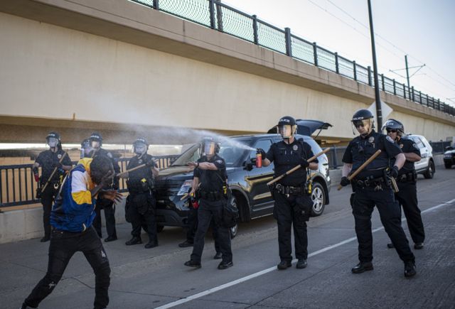 7. A demonstrator is sprayed with mace by police in Minneapolis, Minnesota, while protesting the killing of an unarmed black man, George Floyd, by a police officer.
