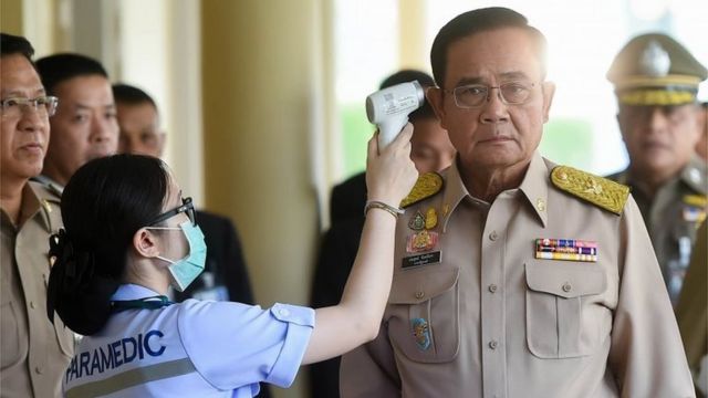 a paramedic checking the temperature of Thai Prime Minister Prayut Chan-o-cha (R) as authorities increase preventive measures against the spread of the coronavirus, at the Government House in Bangkok, Thailand, 02 March 2020