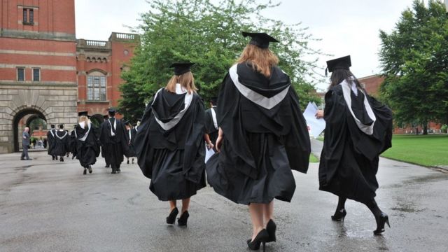 3 women graduates wearing gowns on graduation day
