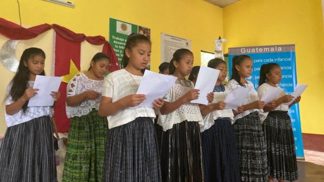 Girls singing the ABBA song in a school.